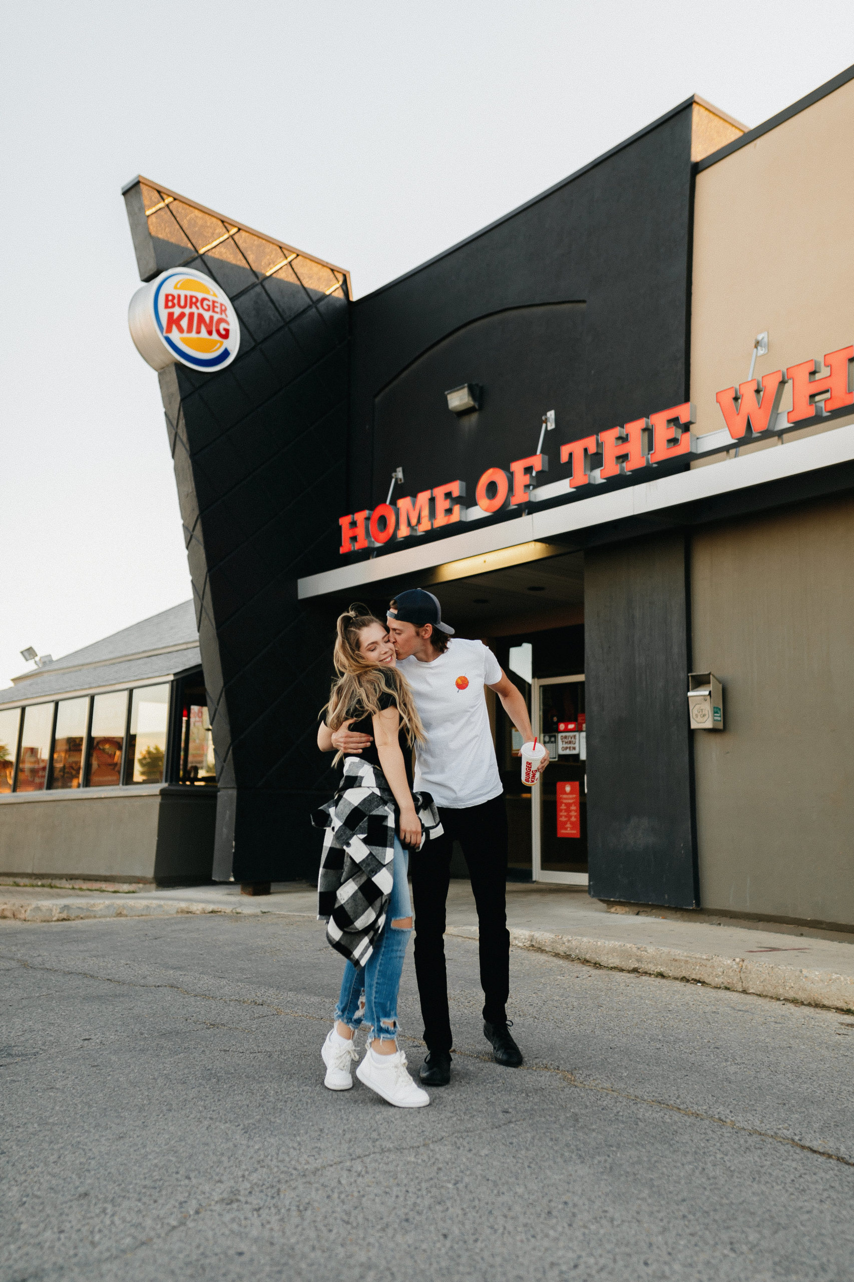 couple kissing in front of burger king