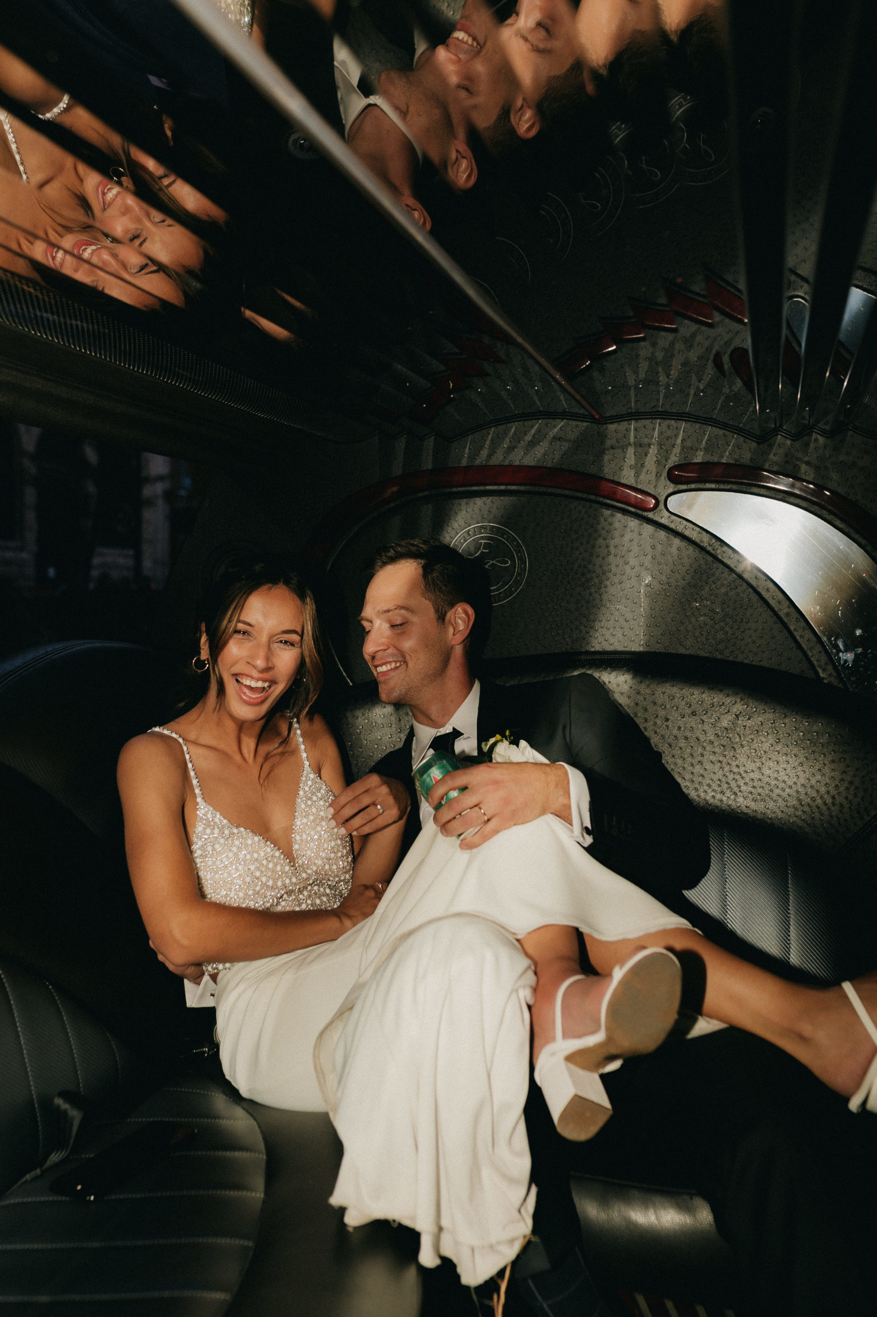 Bride & Groom laughing in a limo