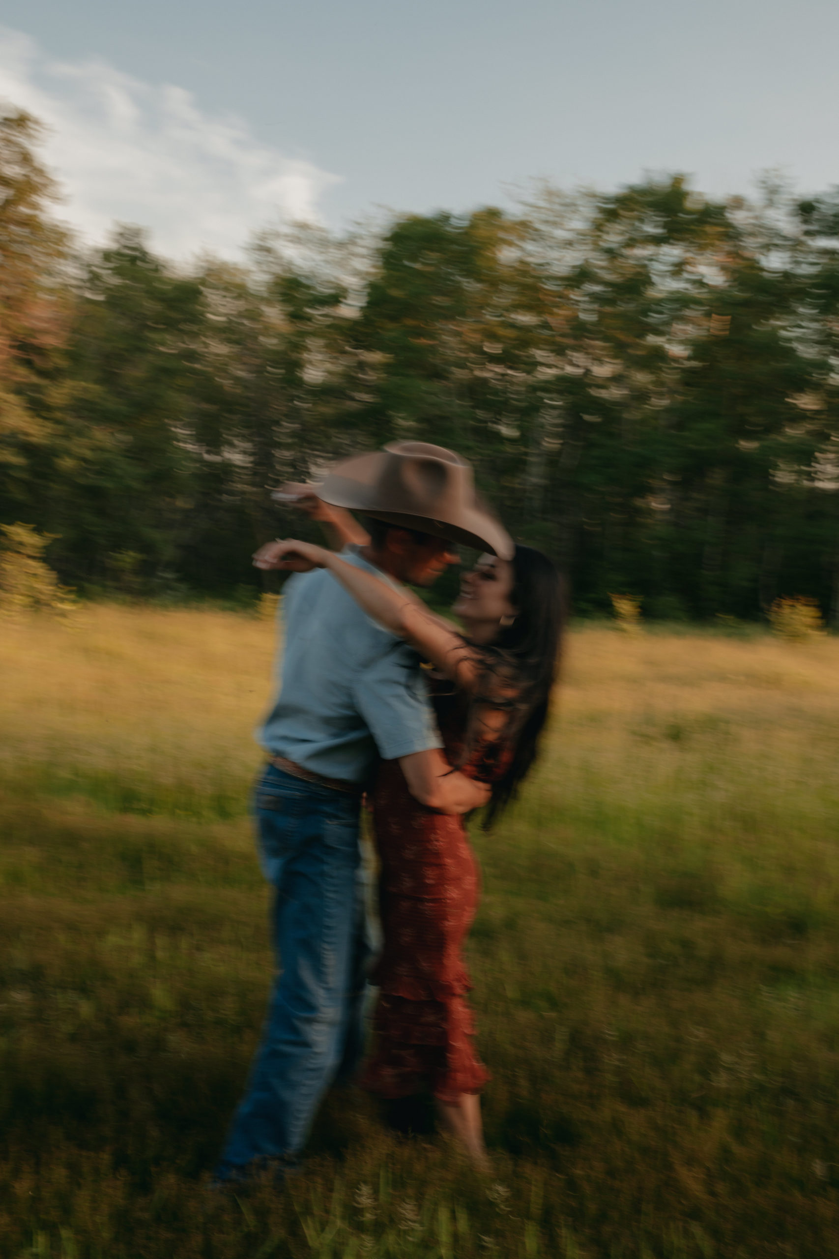 blurred couple dancing in a field