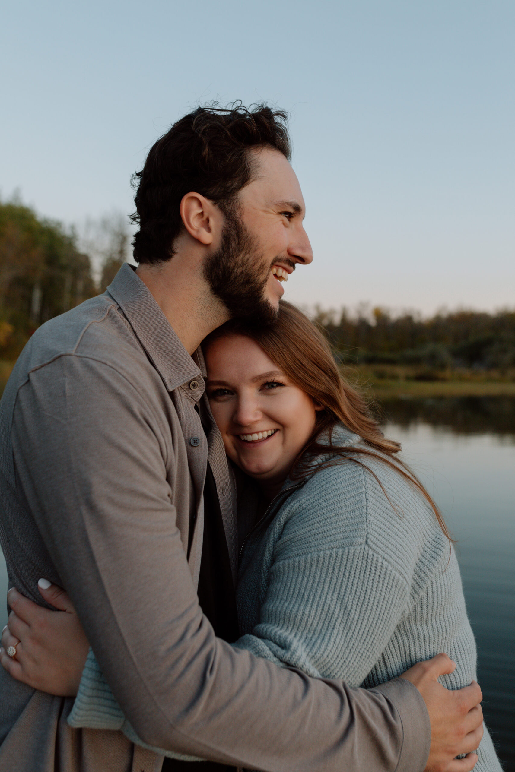 Engaged couple hugging at Caddy Lake