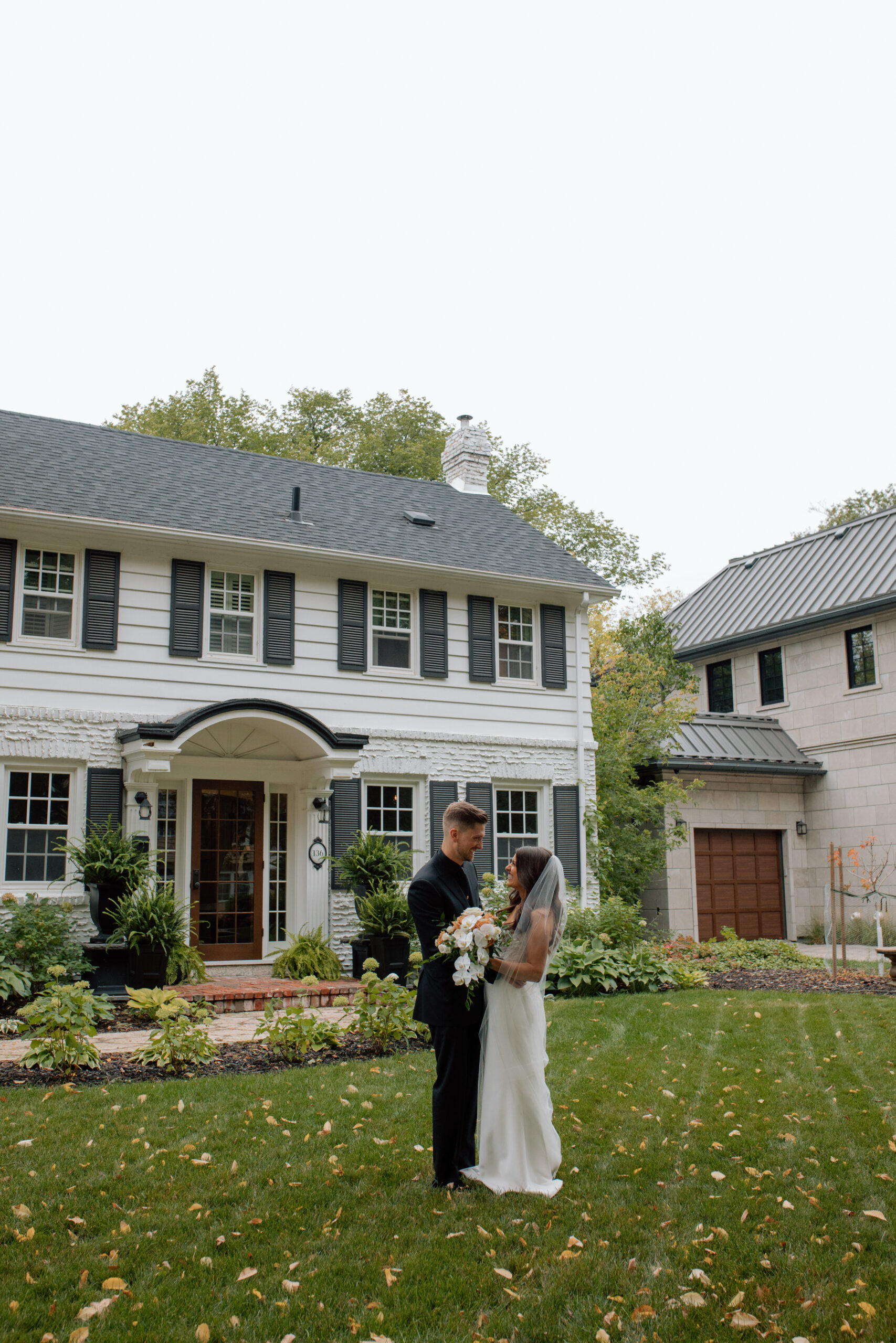 Bride & Groom in front of house