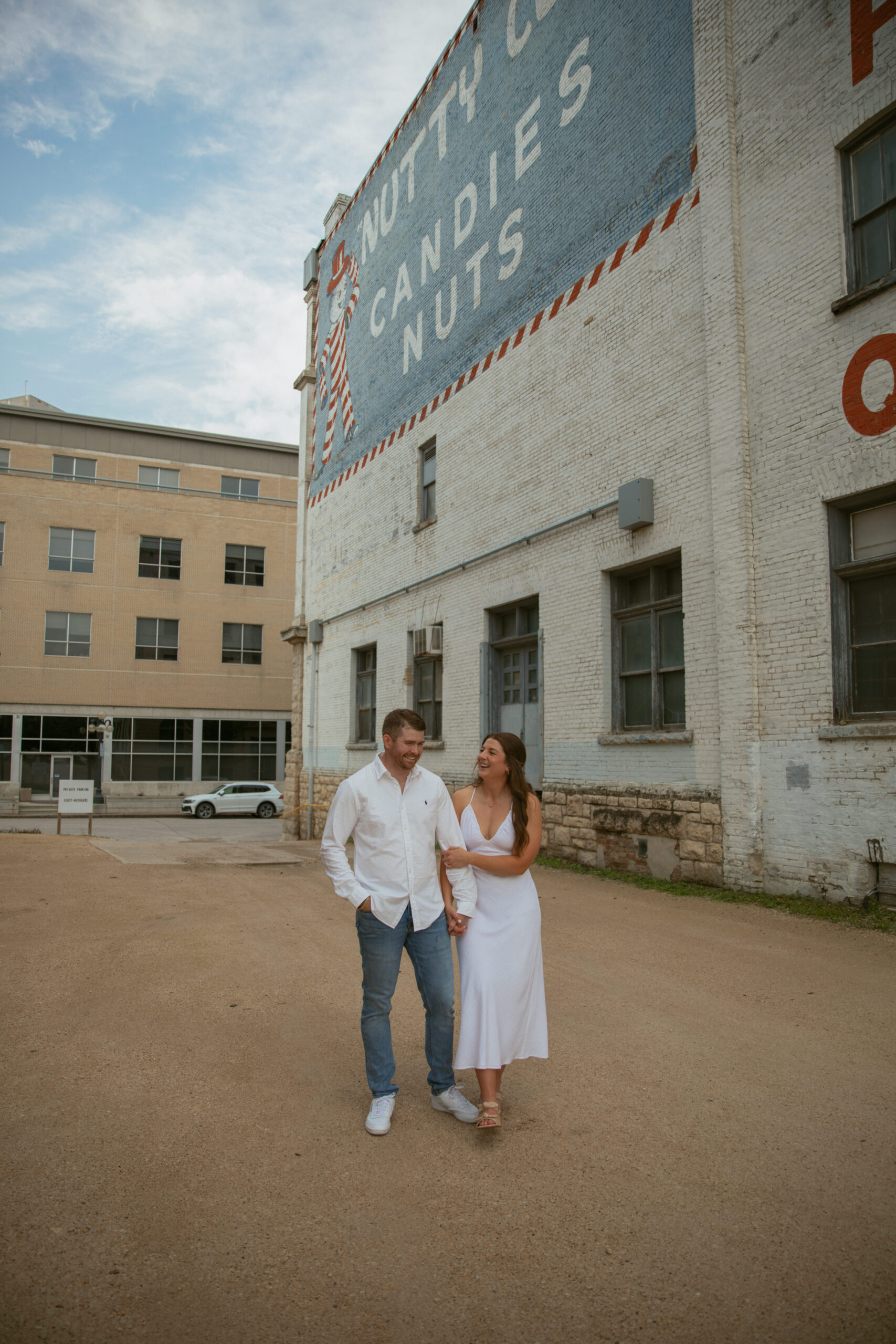 couple holding hands in downtown