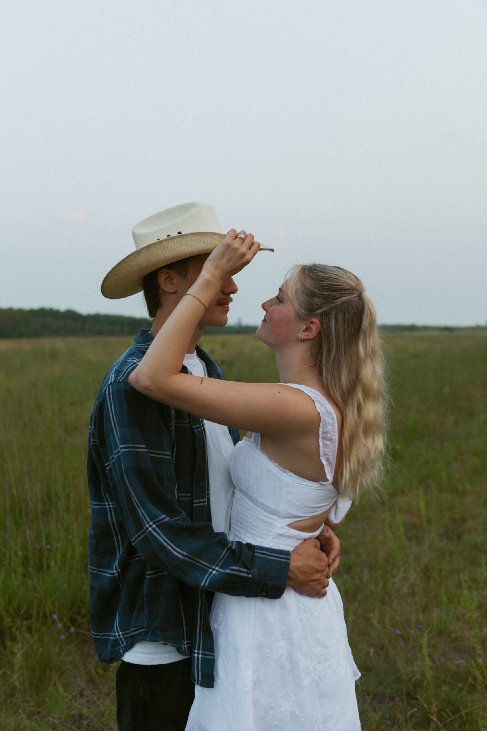 Cowboy couple in a field