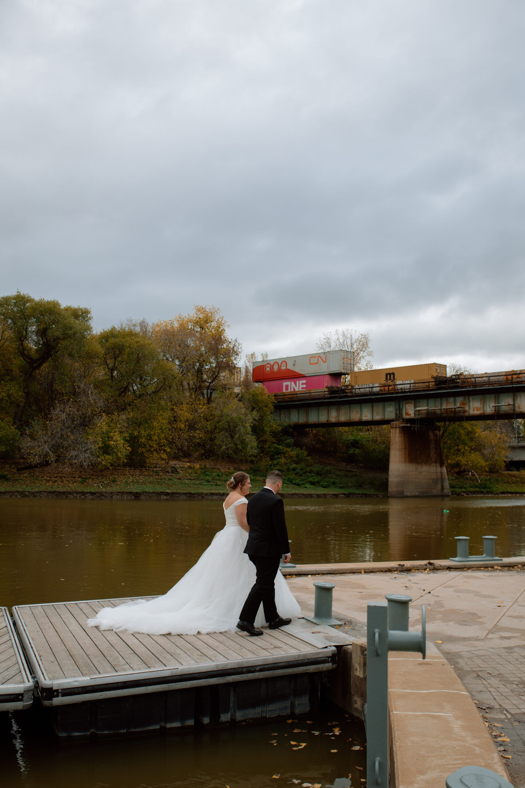 Bride & Groom walking on bridge