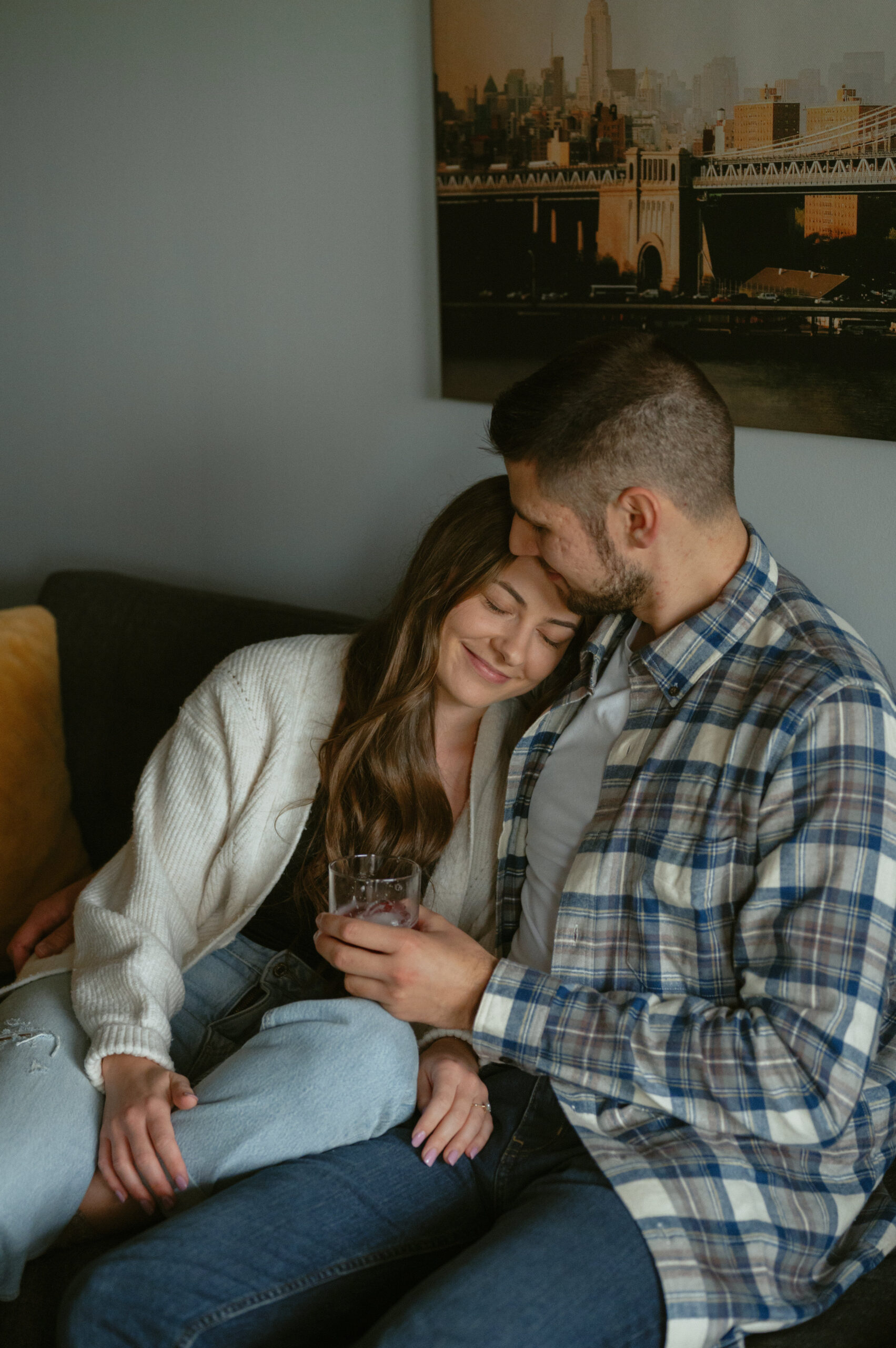 Couple cuddling on their couch