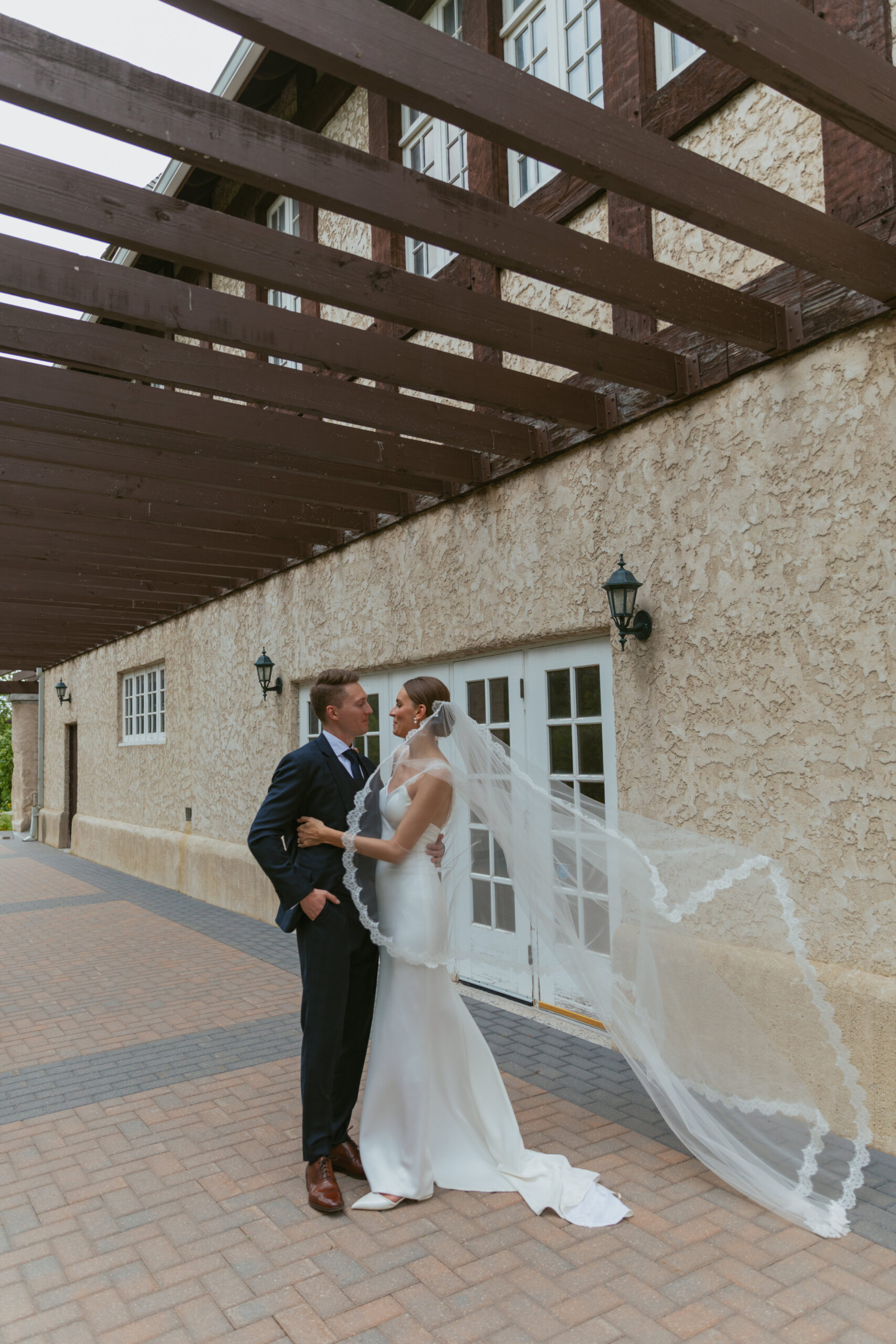 Bride & Groom kissing. Long veil.