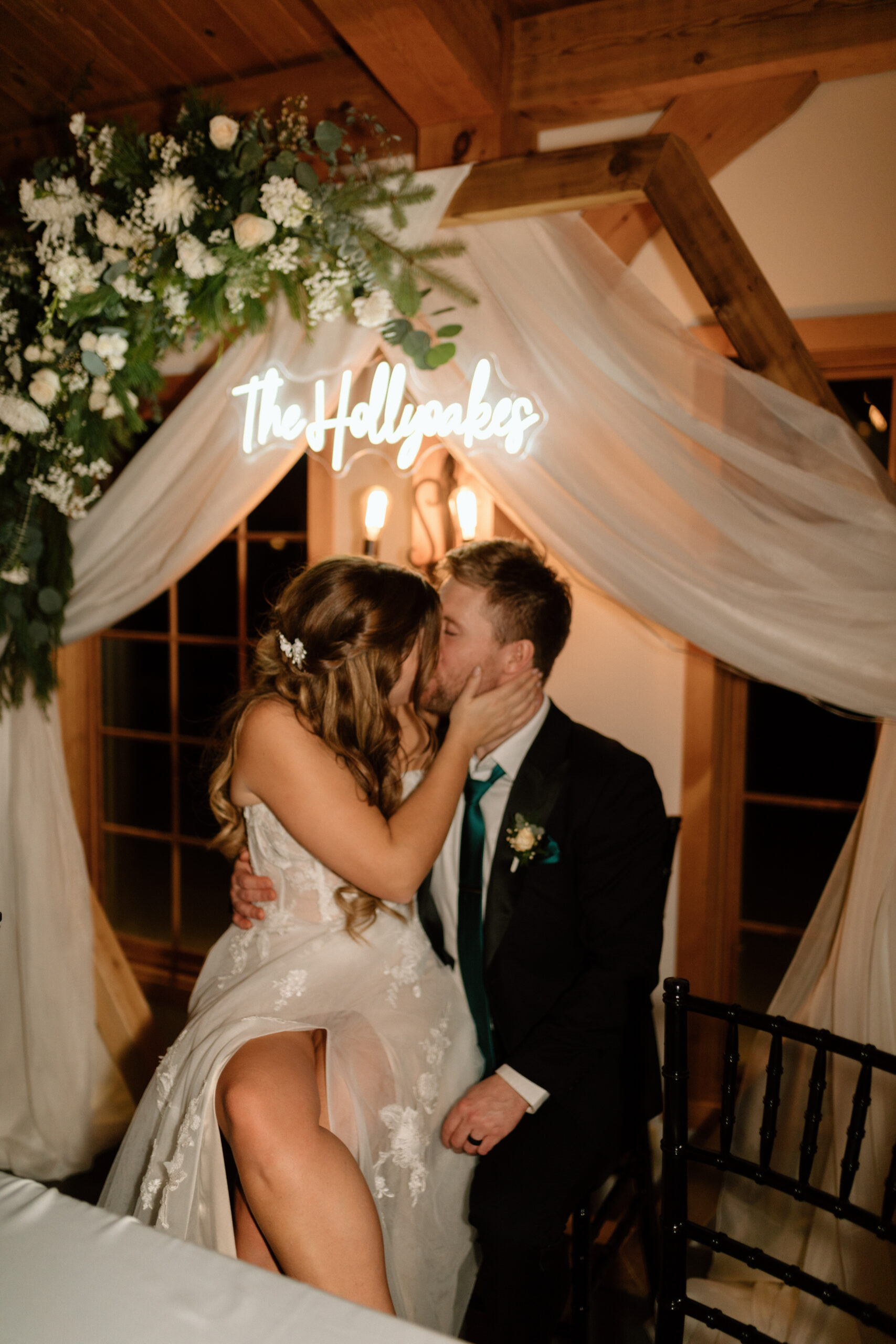 Bride & Groom kissing under neon sign