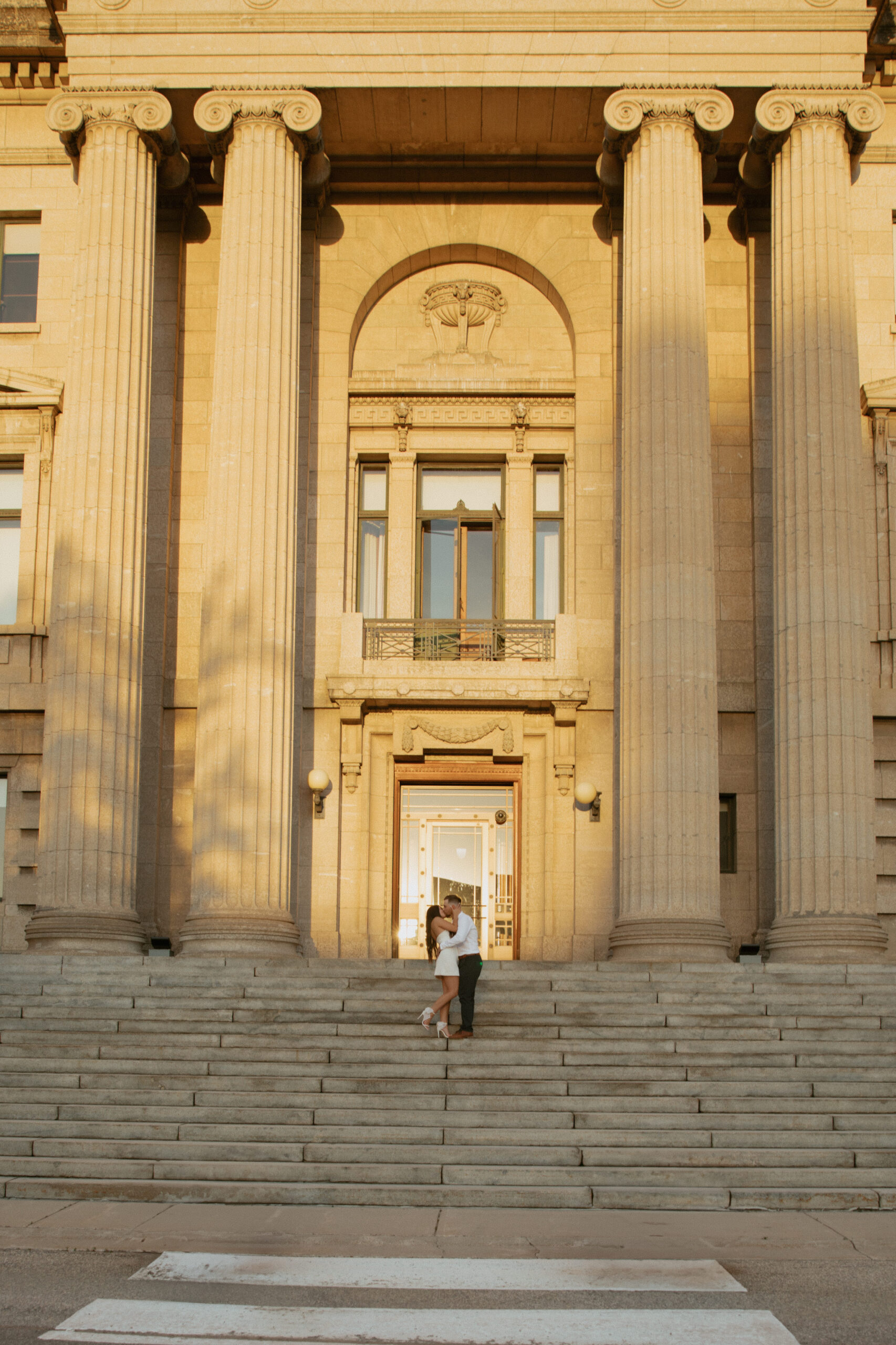 Couple kissing in front of legislative building