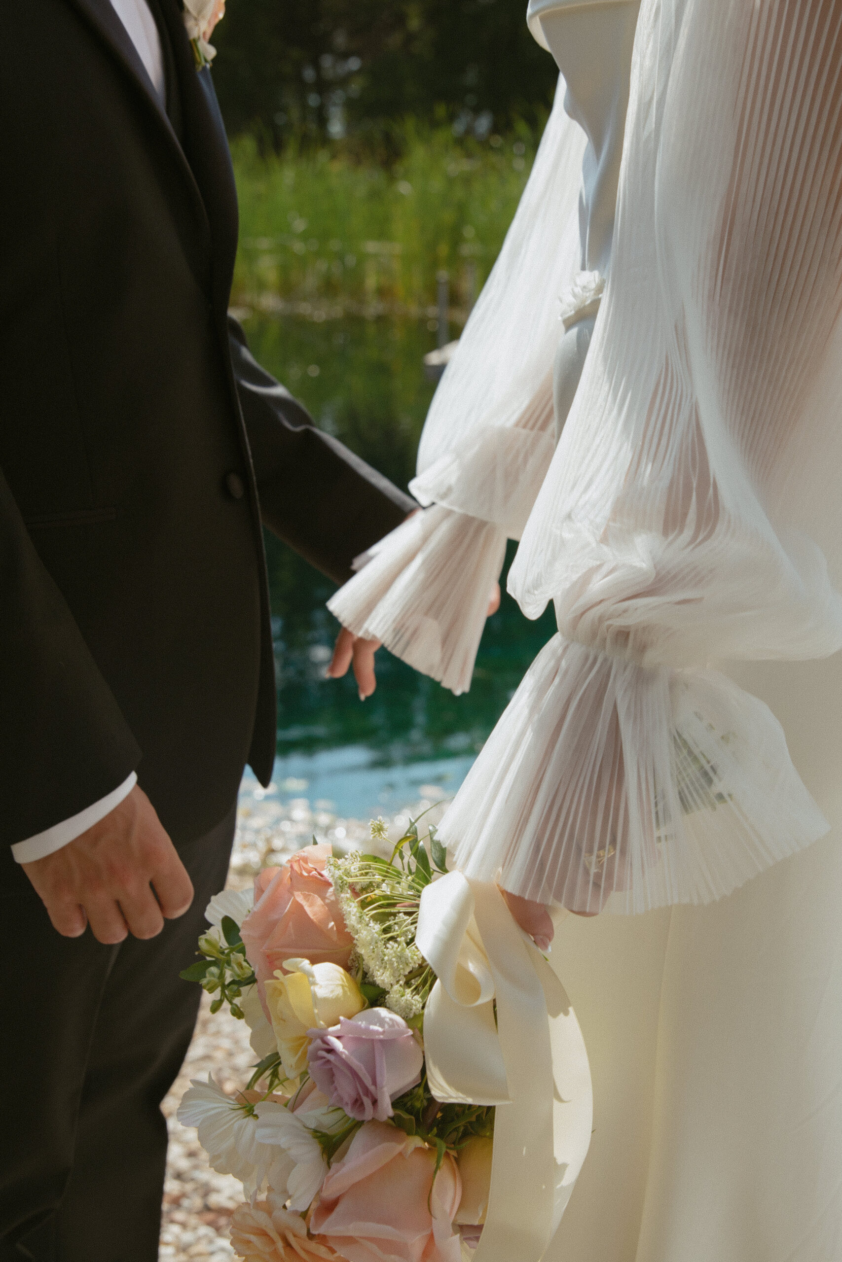 bride and groom by a lake