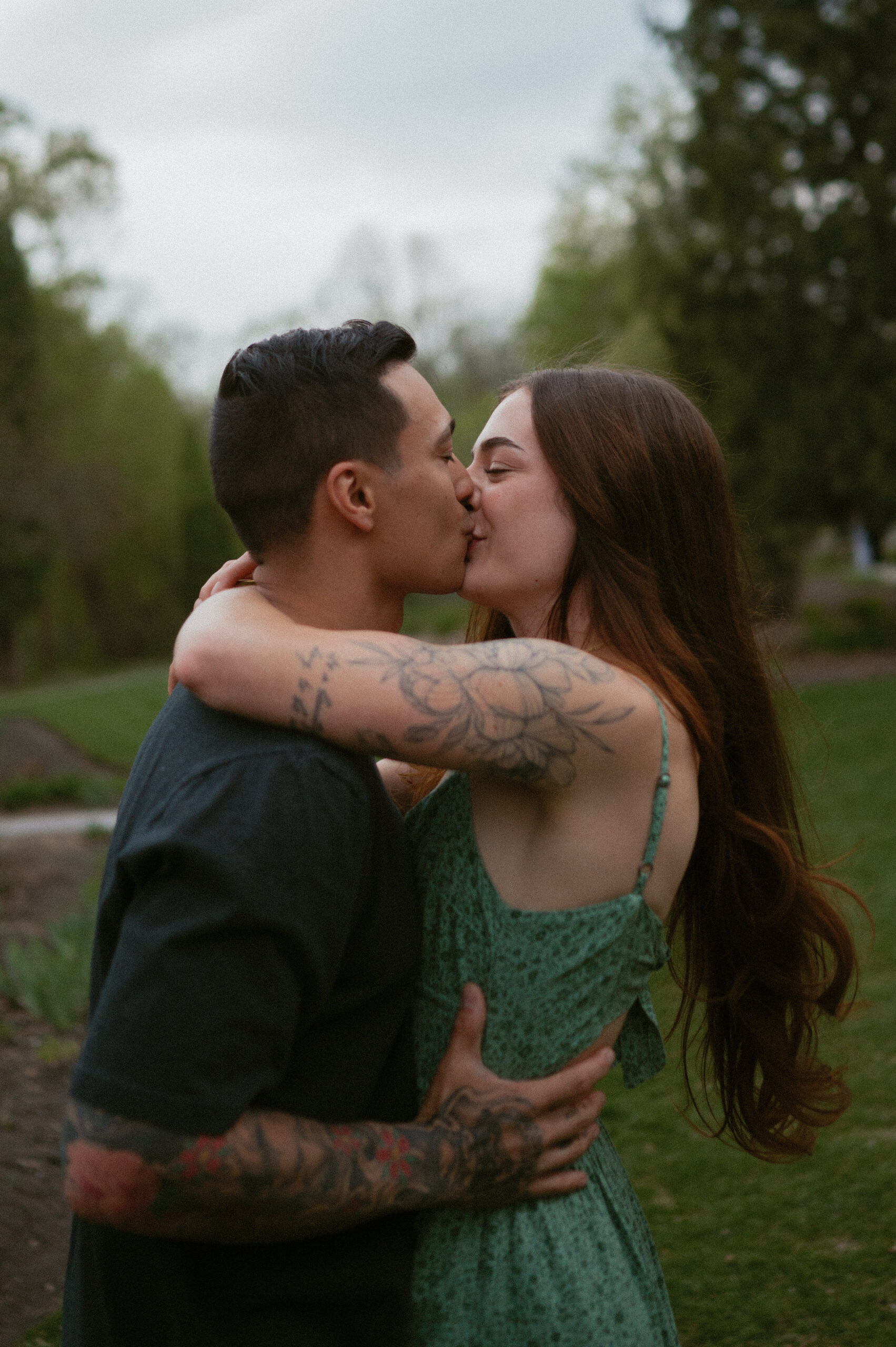 Couple embracing and kissing in a park