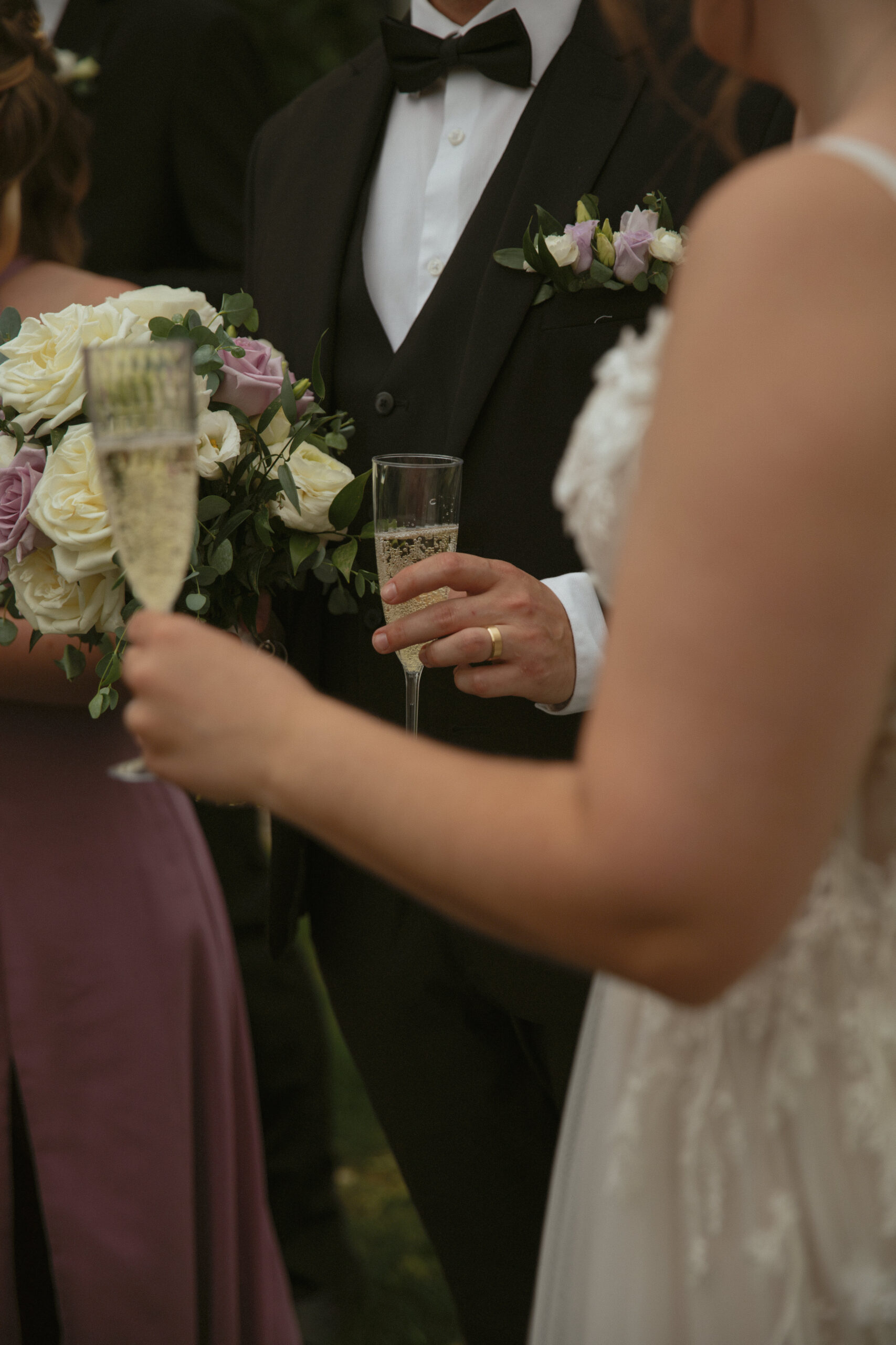 Groom holding champagne glass