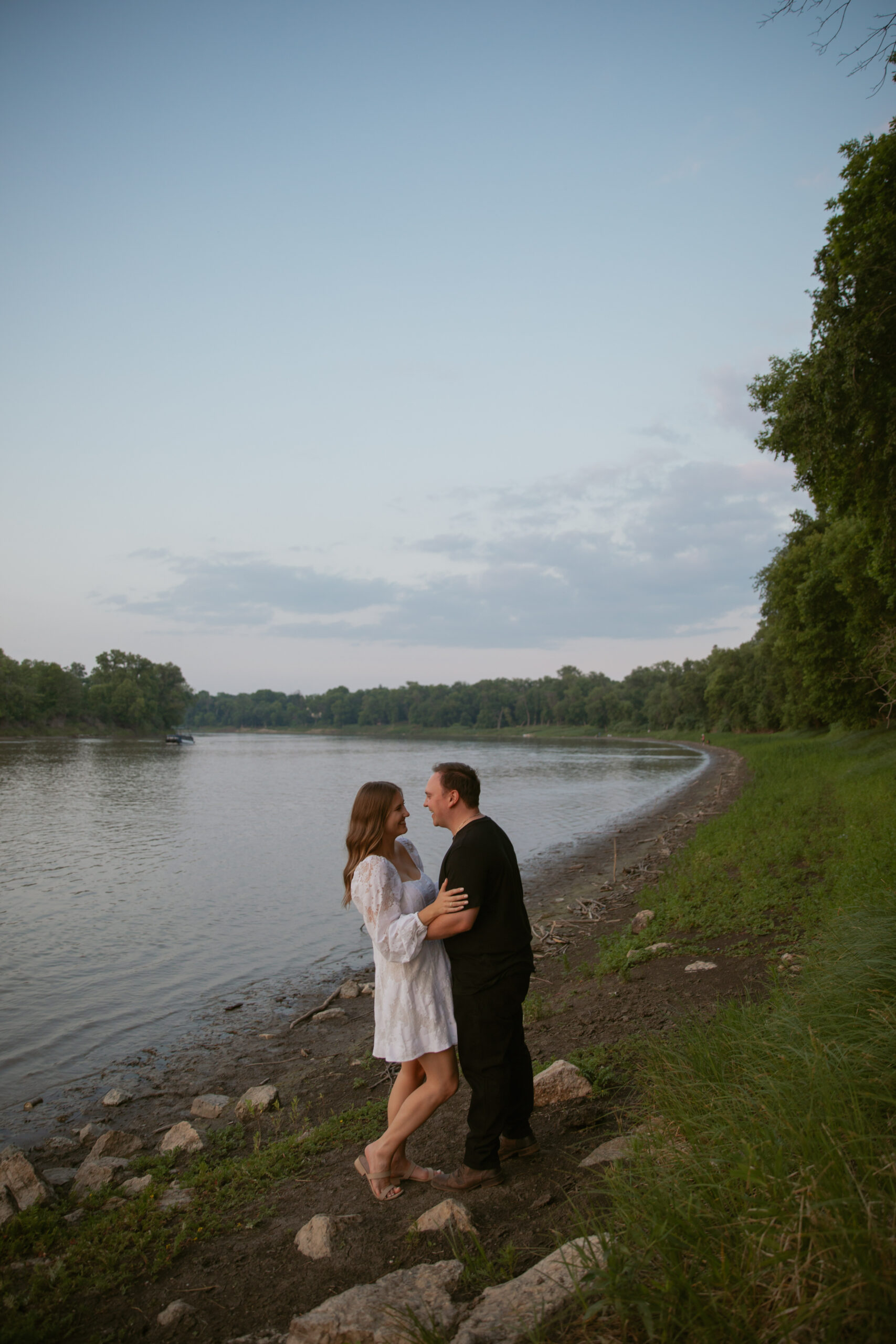 Couple laughing on a river bank