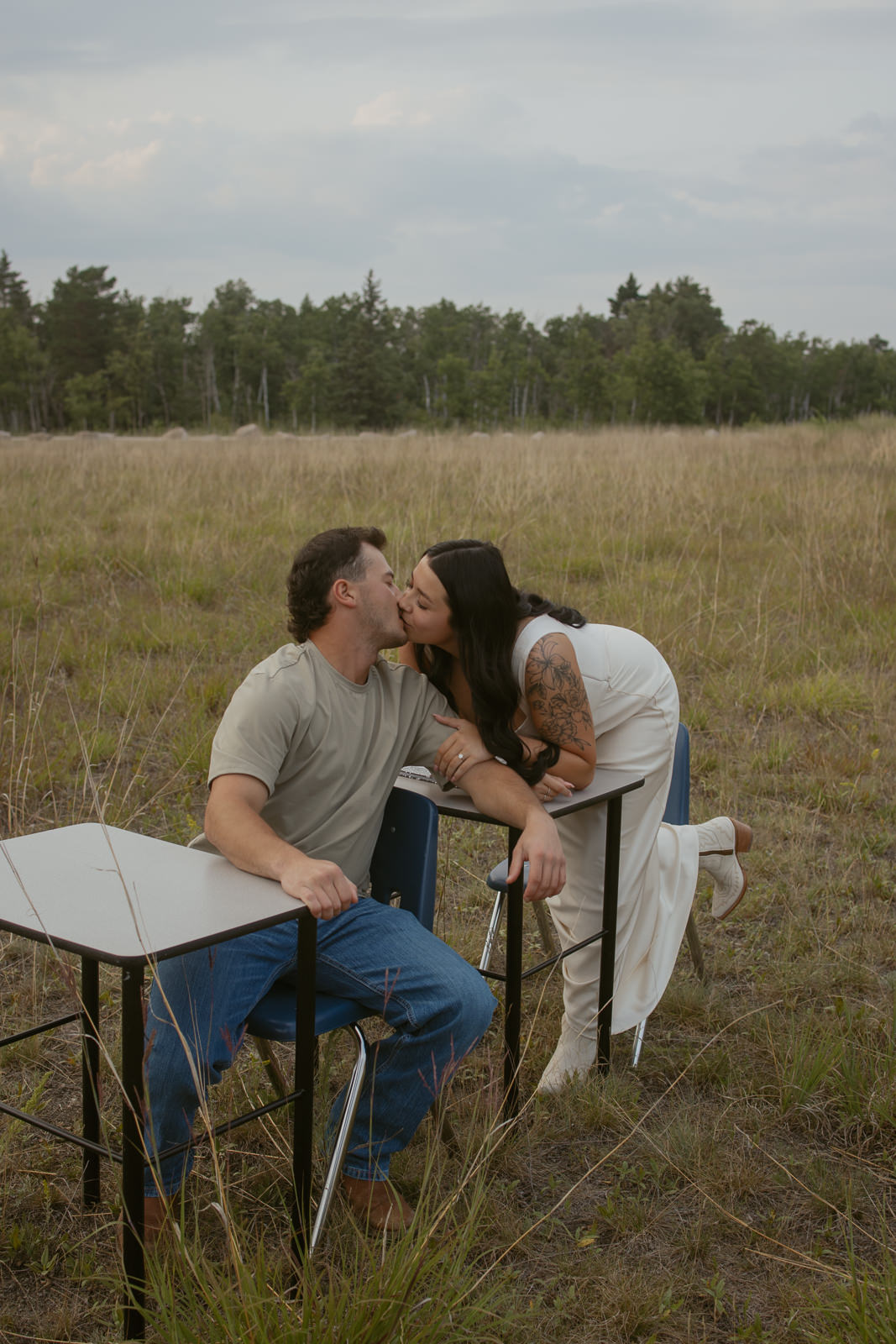 Couple sitting at school desks smooching