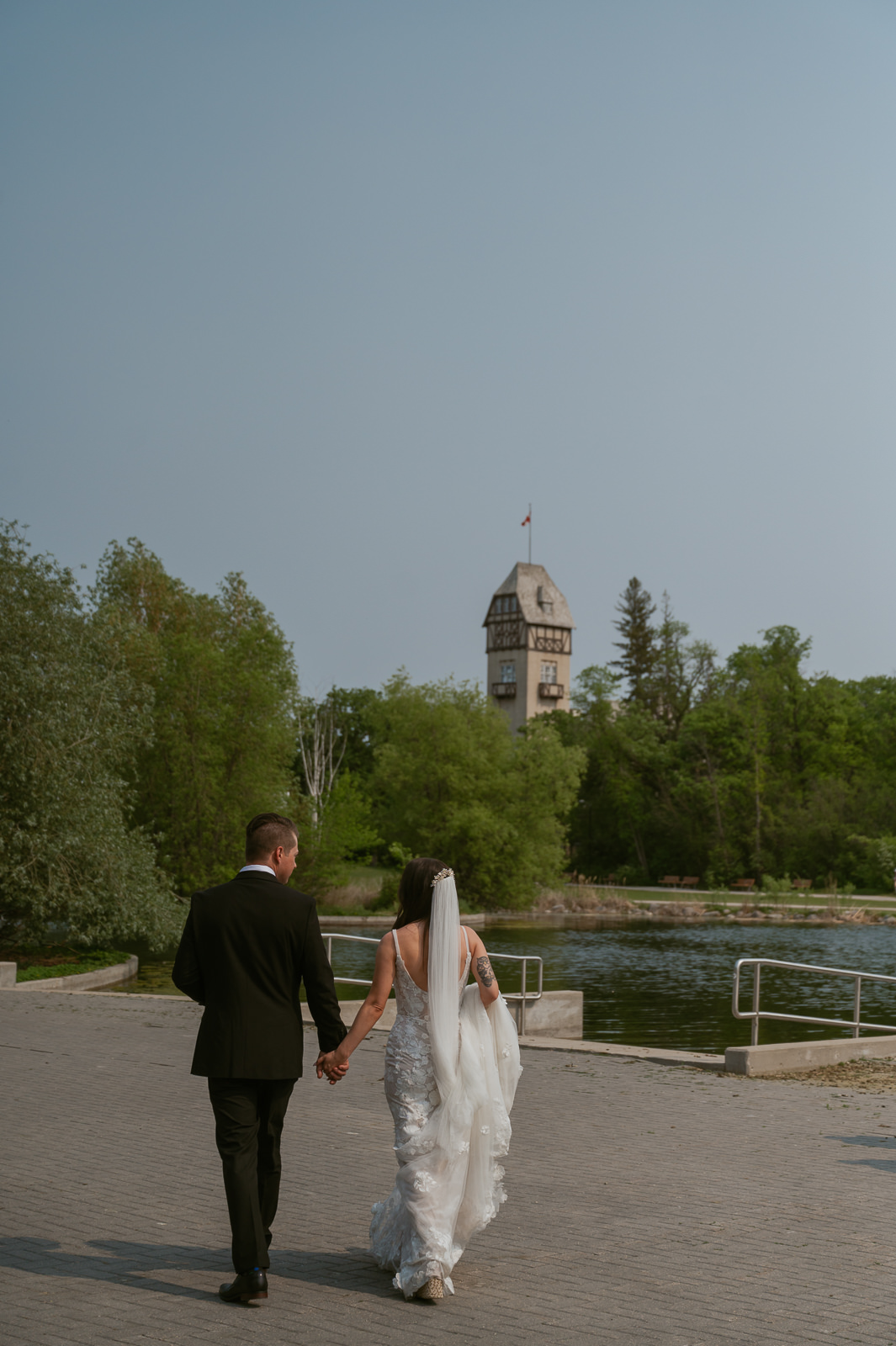 Bride & Groom walking towards Pavilion